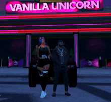 a man and a woman standing in front of a vanilla unicorn sign