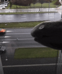 a car is driving down a street with an arrow pointing left