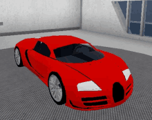 a red car is sitting in a room with a window