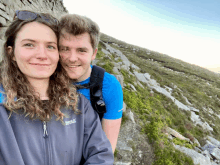 a man and a woman are posing for a picture and the woman is wearing a jacket that says regatta on the front