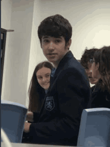 a group of students are sitting in a classroom .