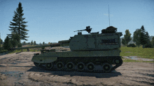 a green tank is parked on a dirt road with a few trees in the background