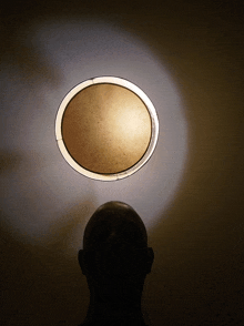 a person is looking up at a circle of light