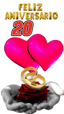 a couple of hands holding hearts and wedding rings with the words feliz aniversario 20