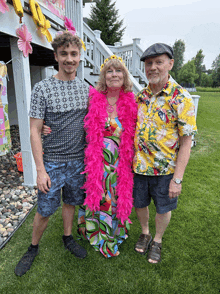 a group of people posing for a picture with one wearing a pink boa