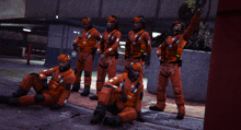 a group of people wearing orange jumpsuits and helmets with the word rescue on them