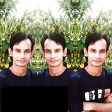 a man wearing a blue shirt with the letter t on it poses in front of a tree