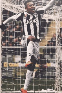 a soccer player in a jeep jersey celebrates his goal