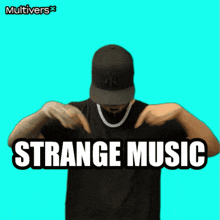 a man wearing a ny hat and a necklace is pointing at the word strange music