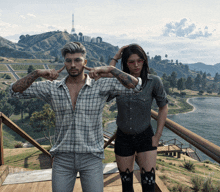 a man and a woman are posing for a picture with a hollywood sign in the background