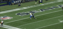 a seahawks player catches a pass during a game