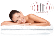 a woman is smiling while laying on a white towel with a fit bodywrap logo in the background