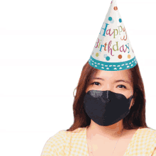 a woman wearing a birthday hat and a black face mask