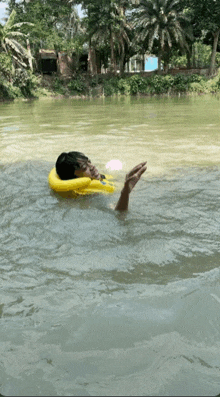 a man in a life jacket is swimming in a river