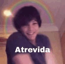 a blurry picture of a person with a rainbow in the background and the word atrevida .