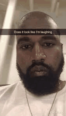 a man with a beard is making a funny face on a snapchat .