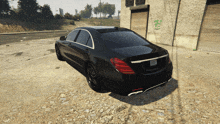 a black mercedes is parked in a parking lot with a building in the background