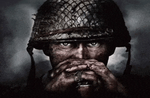 a close up of a soldier covering his mouth