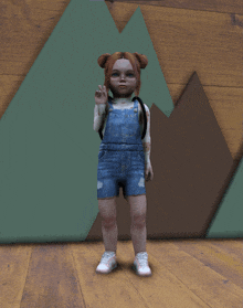 a little girl wearing overalls and white sneakers stands in front of a mountain