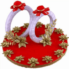 a pair of wedding rings sitting on top of a red tray .