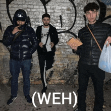 three men standing in front of a brick wall with the word weh written on the bottom