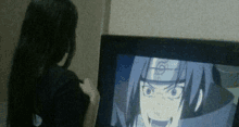 a woman is looking at a cartoon on a television screen