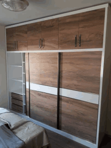 a bedroom with a sliding door wardrobe and a bed