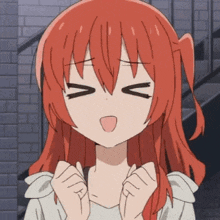 a girl with red hair is making a face with her eyes closed