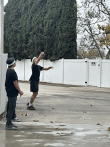 a white fence has a sign that says no parking