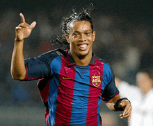 a soccer player wearing a shirt with a fcb logo on it