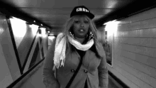 a black and white photo of a woman wearing a hat that says grrr