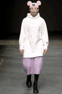 a man wearing a mickey mouse hat and a white sweatshirt with the word selfie on it