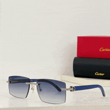 a pair of blue cartier sunglasses sits on a table