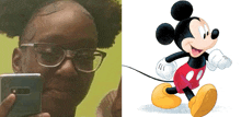 a girl taking a selfie next to a mickey mouse cartoon