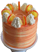 a cake with whipped cream and oranges on top