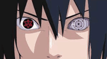 a close up of sasuke uchiha 's eyes with a star in the middle of them .