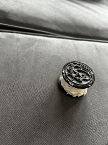 a black and white photo of an oreo cookie sitting on a couch