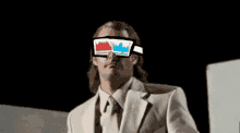 a man wearing a suit and tie is wearing 3d glasses