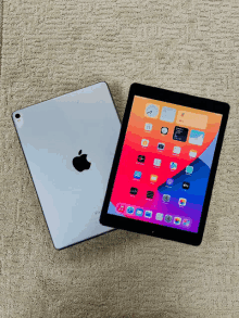 an apple ipad is sitting on a carpet next to another ipad