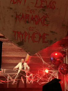 a karaoke tryphone sign hangs from a ceiling