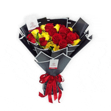 a bouquet of red and yellow roses is wrapped in black paper