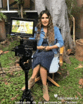 a woman is sitting in front of a camera with the words hablando de su personaje carmen written below her