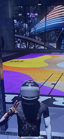 a man wearing a helmet stands in front of a basketball court that says ' nba ' on it