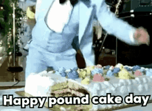 a man in a suit is cutting a large cake with the words `` happy pound cake day '' written on the bottom .