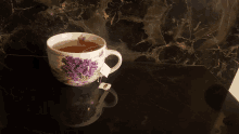 a cup of lavender tea sits on a black counter