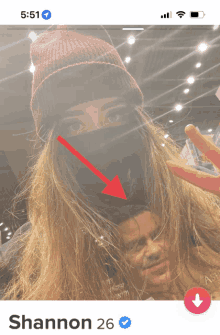 a phone screen shows a woman wearing a beanie and a mask and says shannon 26