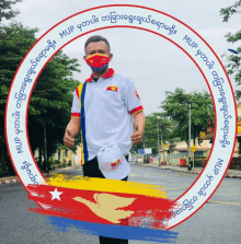 a man wearing a mask and a mup shirt stands in a circle