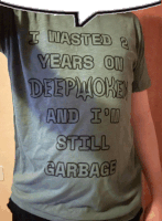 a man is wearing a t-shirt that says i wasted 2 years on deepmoken and i 'm still garbage