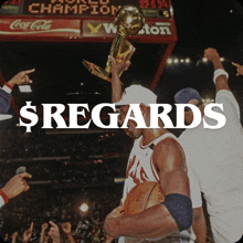 a basketball player is holding a trophy in front of a scoreboard that says coca-cola