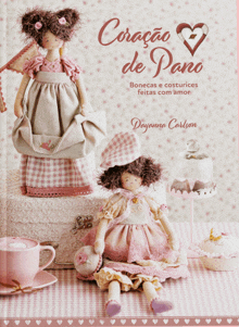 a book called coracao de pano has two dolls on it